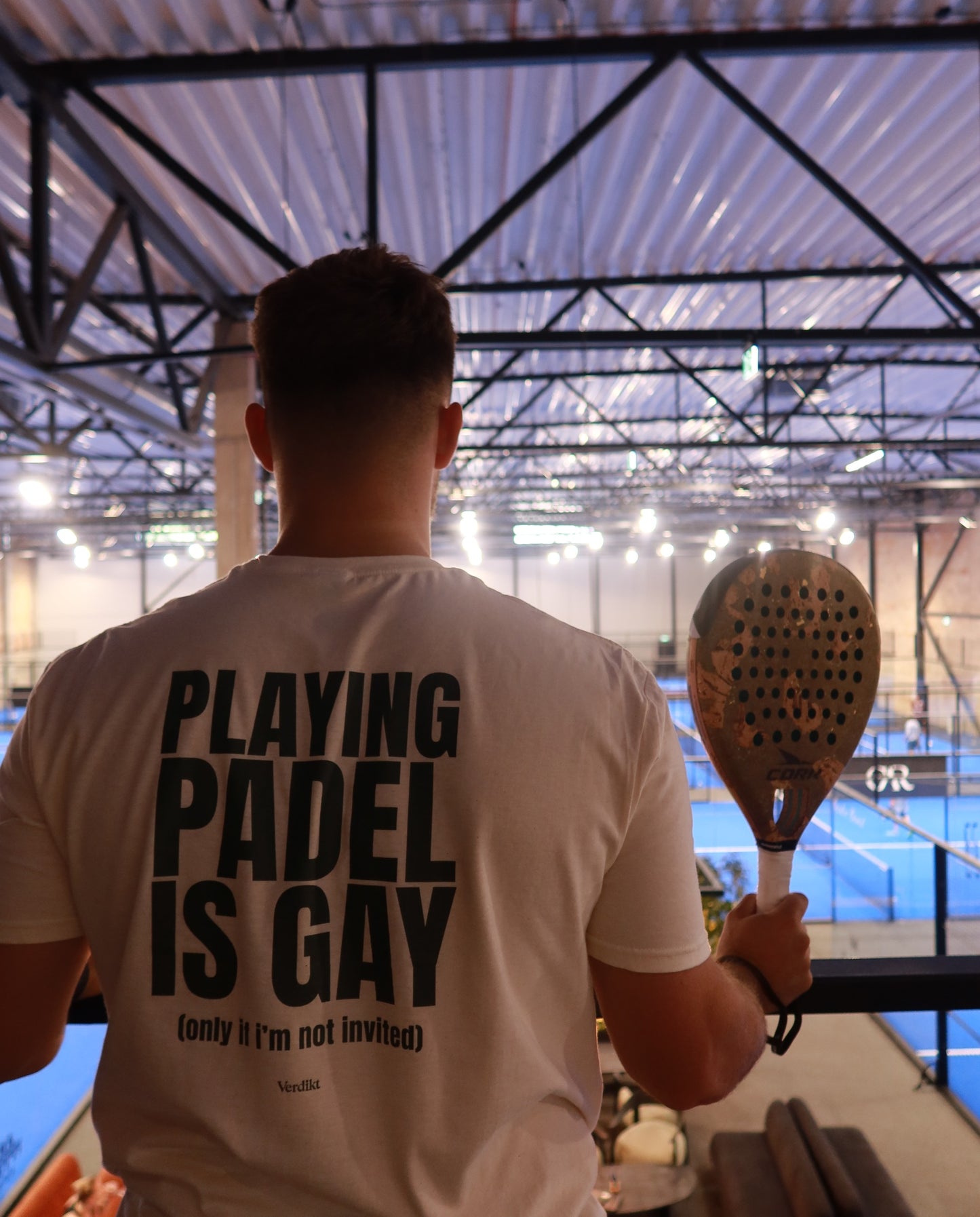 PLAYING PADEL IS GAY print - worn at the padel court, racket in hand