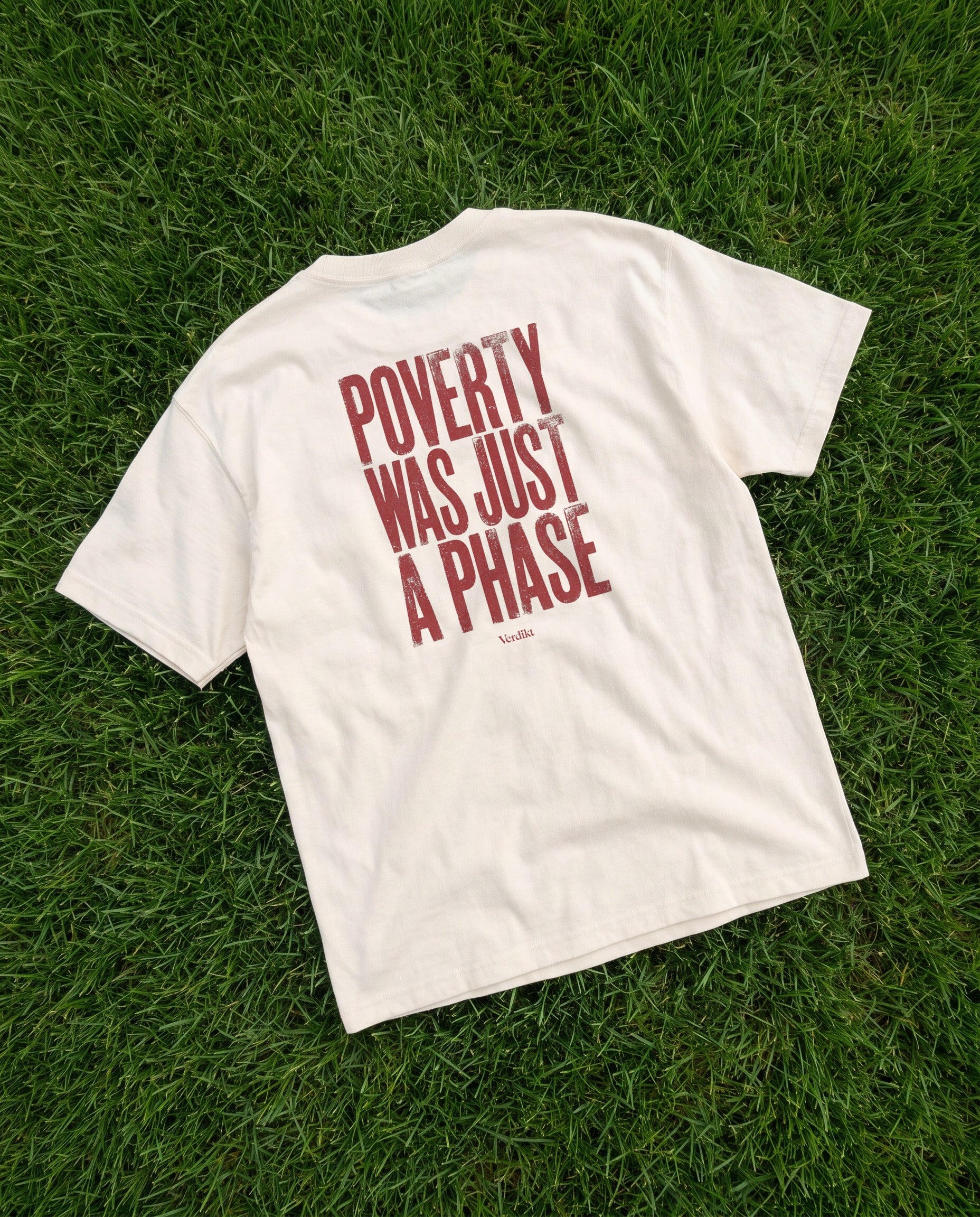 POVERTY WAS JUST A PHASE red print - tee laid on grass